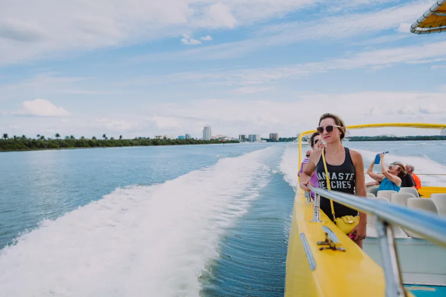 A woman on the Sea Screamer looks out to view dolphins