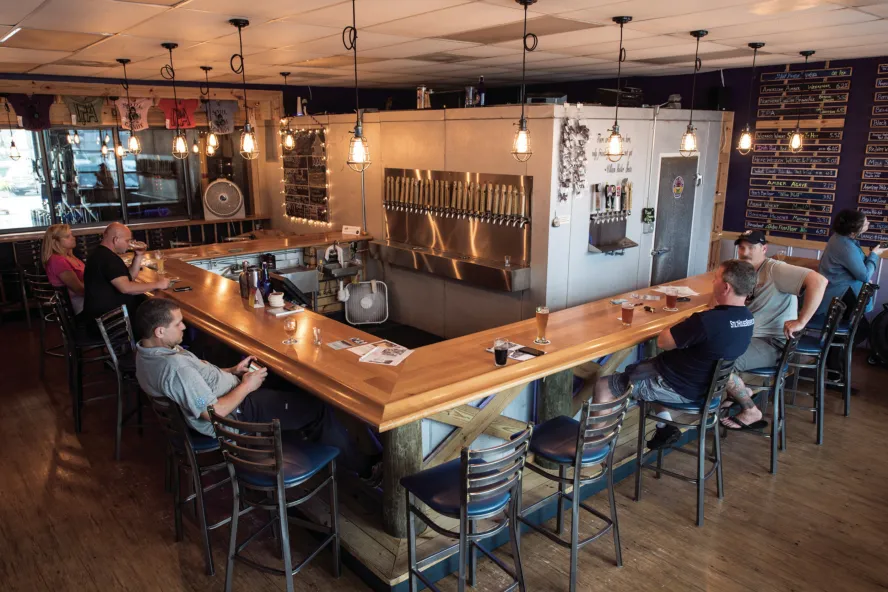 The interior view of Stilt House Brewery showing few people drinking.