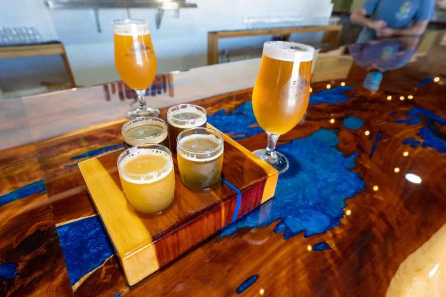 Couple of beer samples on top of a wooden table.