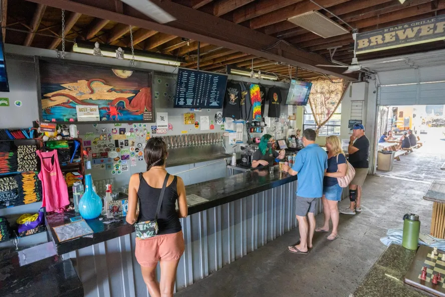 Few people ordering drinks inside Cage Brewing.