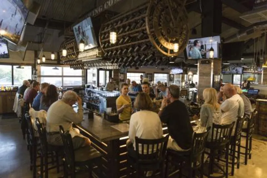 Several people around the bar at Sea Dog Brew Pub.
