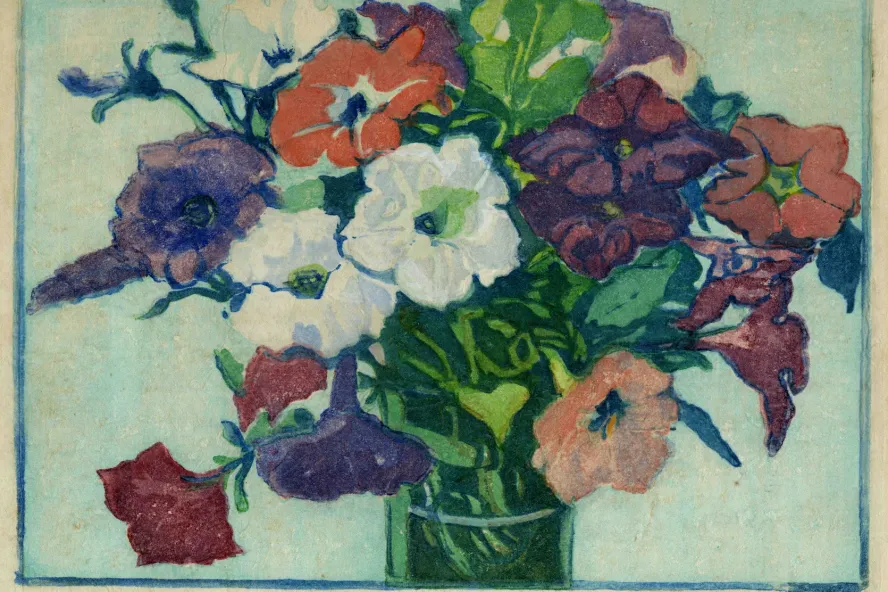 A wood block print featuring a vase full of purple, white, red and yellow petunias.