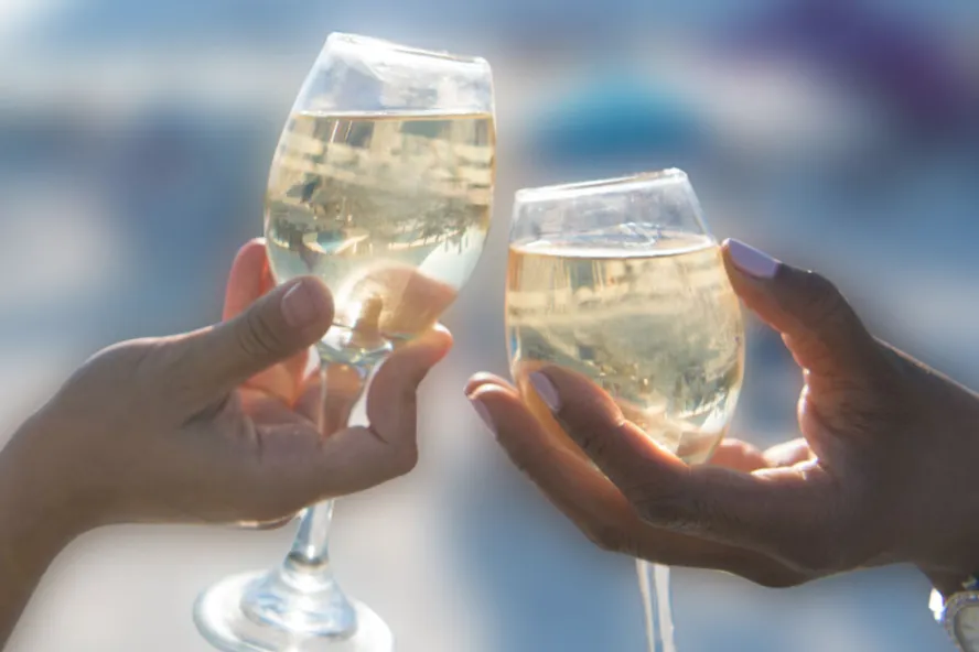 Two wine glasses cheers at Savor The Burg