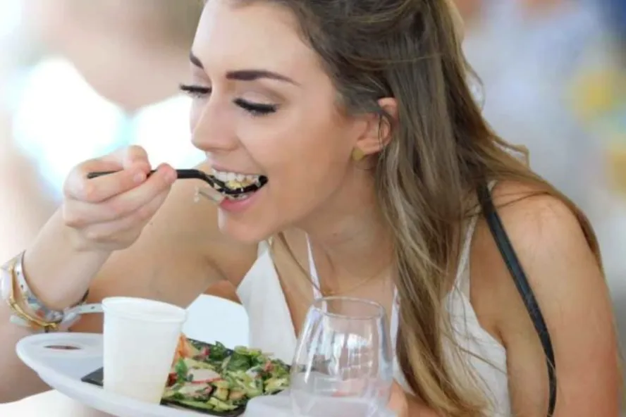 A woman eats a salad at Savor The Burg
