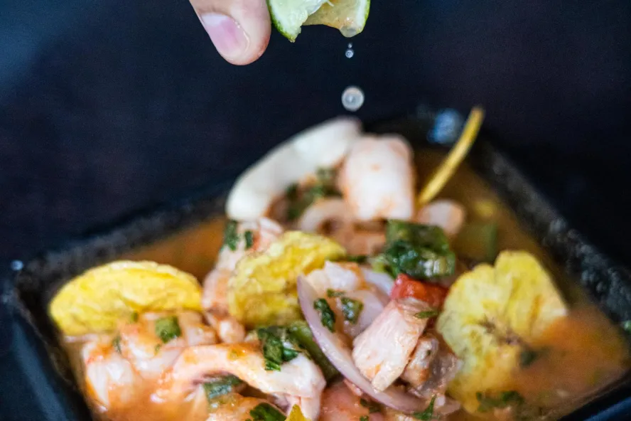 a tight shot of lime squeezed over ceviche