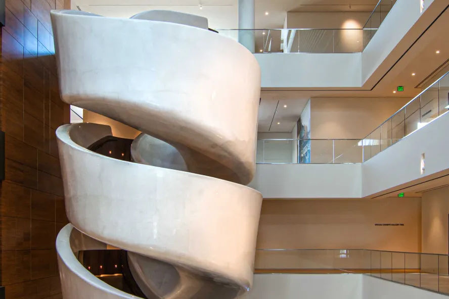 A tightly wound spiral staircase painted white on the exterior.