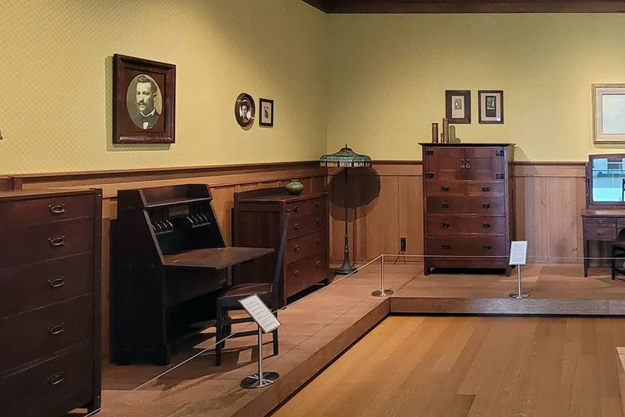 A bedroom decorated with furniture and art from the Arts & Crafts Movement.
