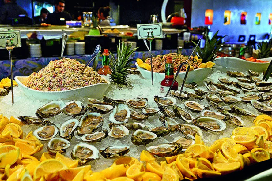 oysters and shrimp are surrounded by cut lemons on a brunch table at Island Way Grill in Clearwater