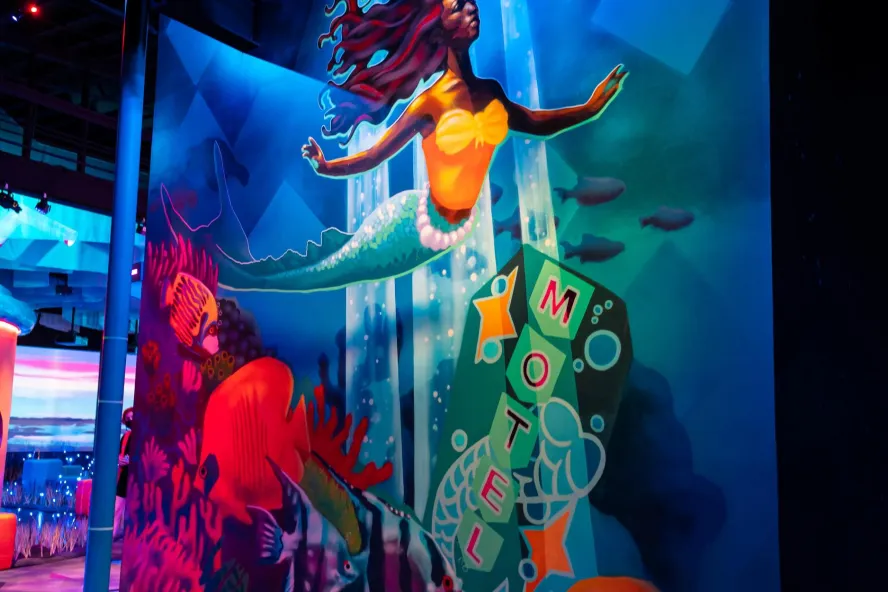 a colorful wall mural depicts a mermaid with a sign for the Mermaid Motel at Fairgrounds St. Pete