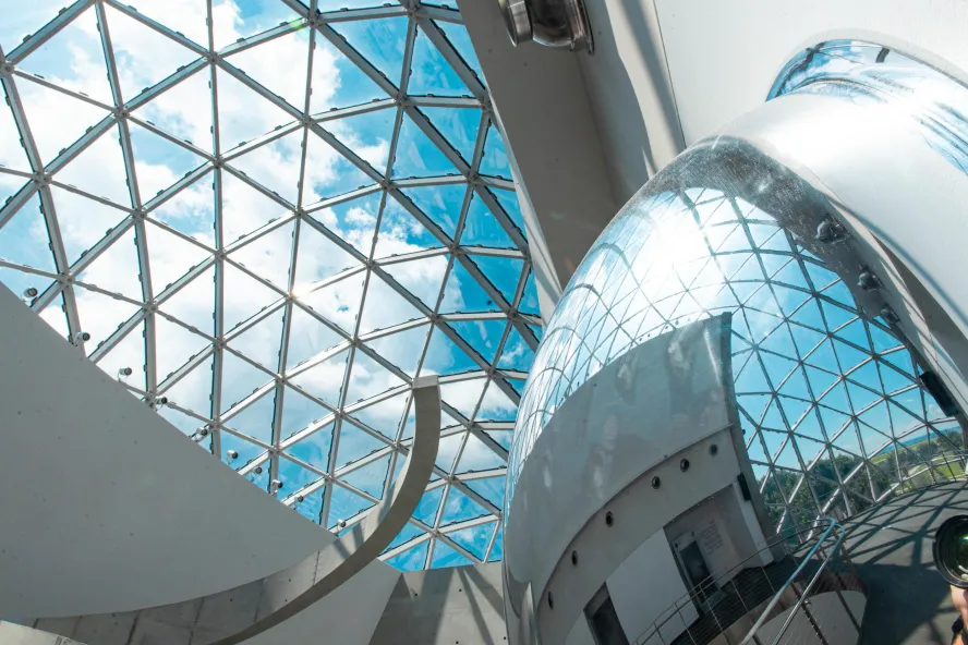blue key and clouds seen through the curved windows of the "enigma" which is part of the Dali Museum in St. Pete Florida