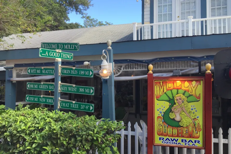 a sign of a mermaid outside Molly Goodheads restaurant in Ozona
