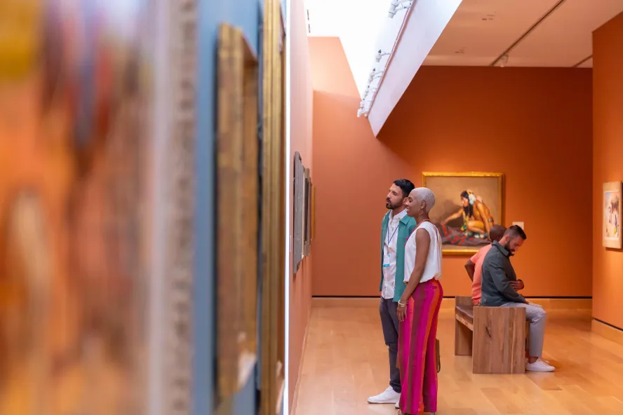 A couple looks at paintings in the James Museum