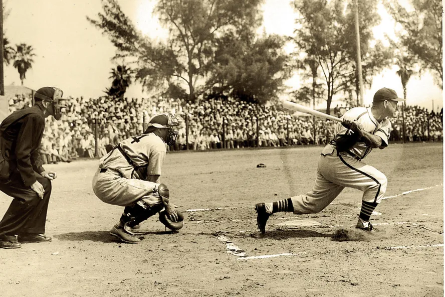 Sepia-toned photo of a batter, catcher and umpire from 1938