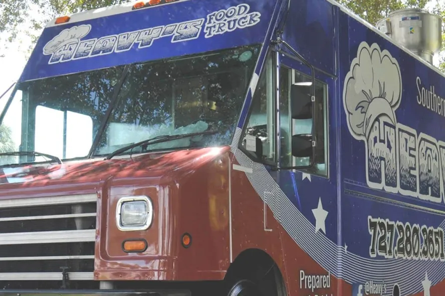 Close-up of a food truck with "Heavy's Food Truck" over the windshield