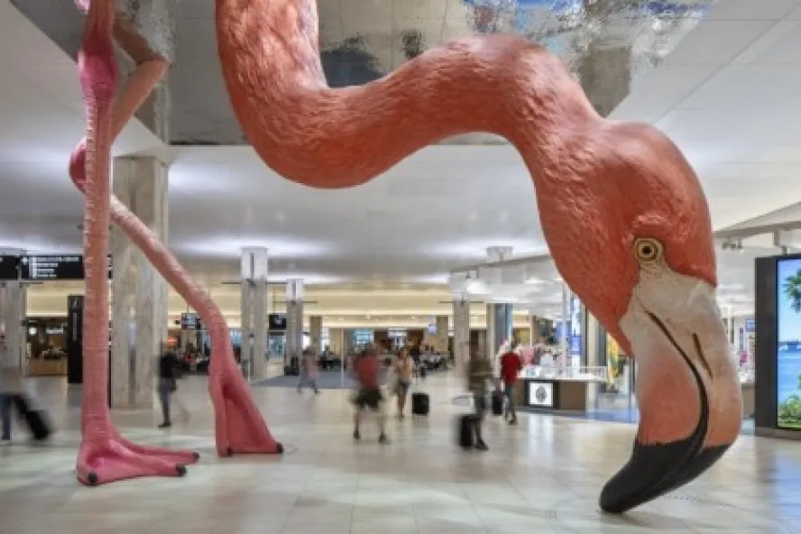 an enormous pink flamingo sculpture with beak to the floor at Tampa International Airport