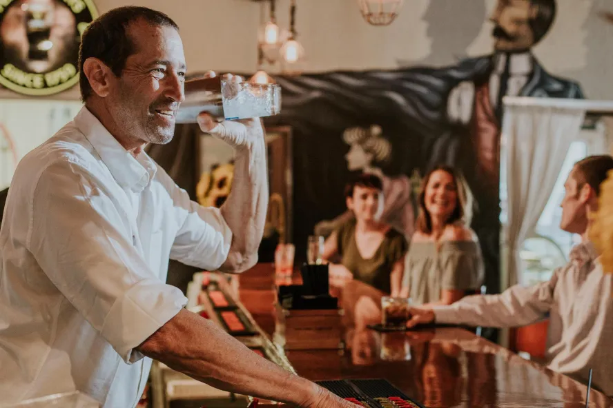 Bartender and people at a bar