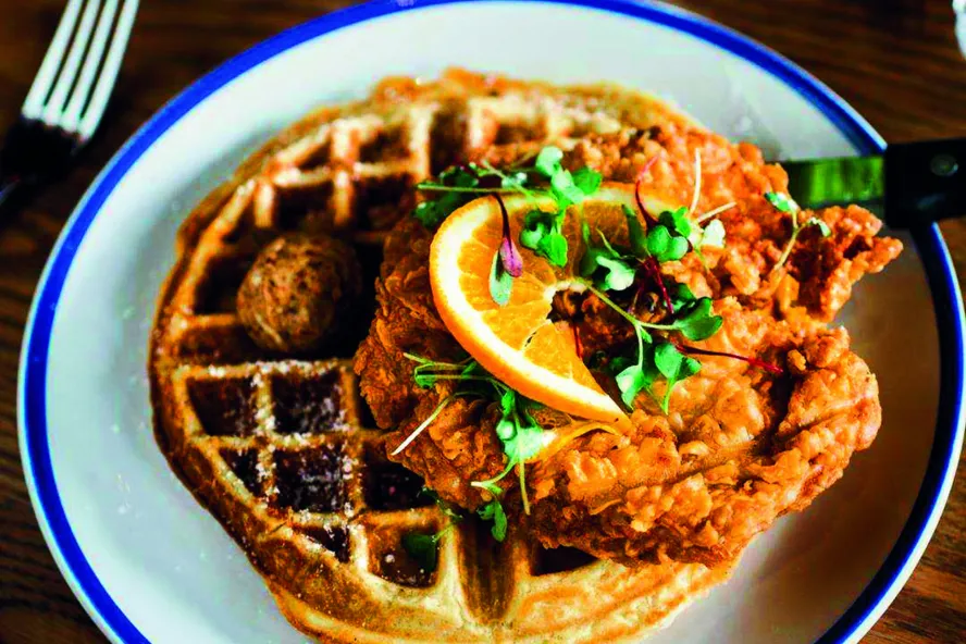 A plate of waffles and chicken