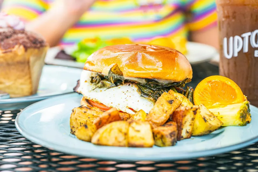 burger on a brioche bun with home fries