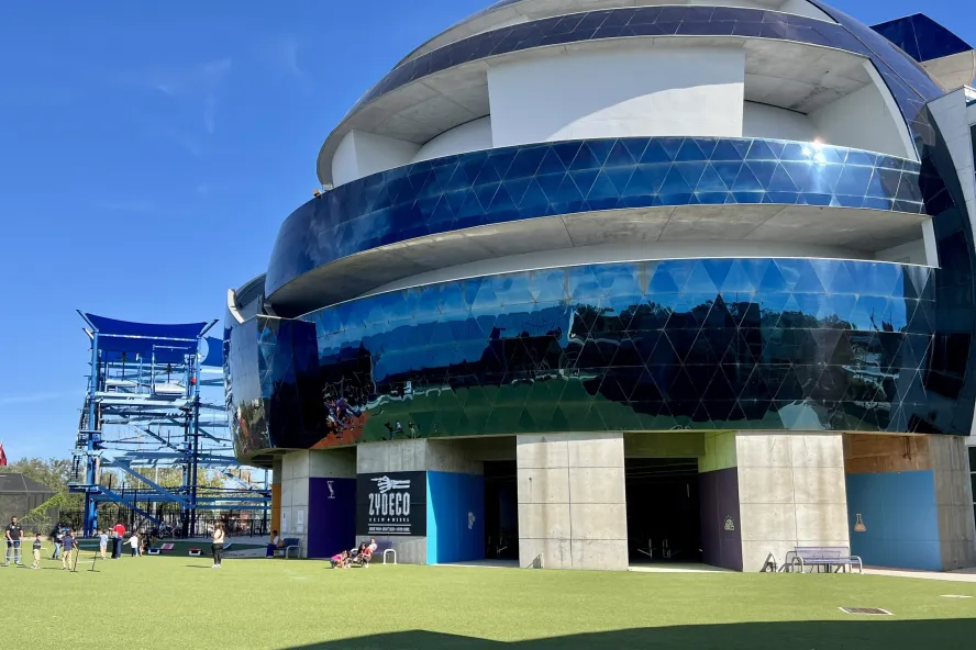 Exterior view of blue dome at MOSI featuring a round dome with blue windows and grassy area surrounding the dome.