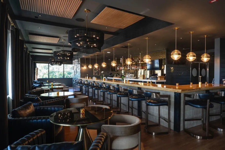 a traditional and elegant bar and tables at Malio's Beach House restaurant