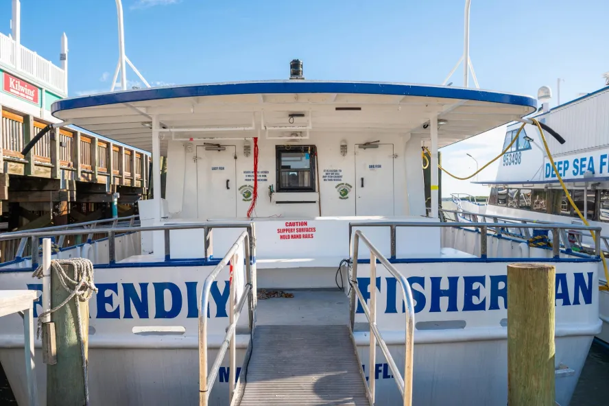 back of boat sitting docked on a pier