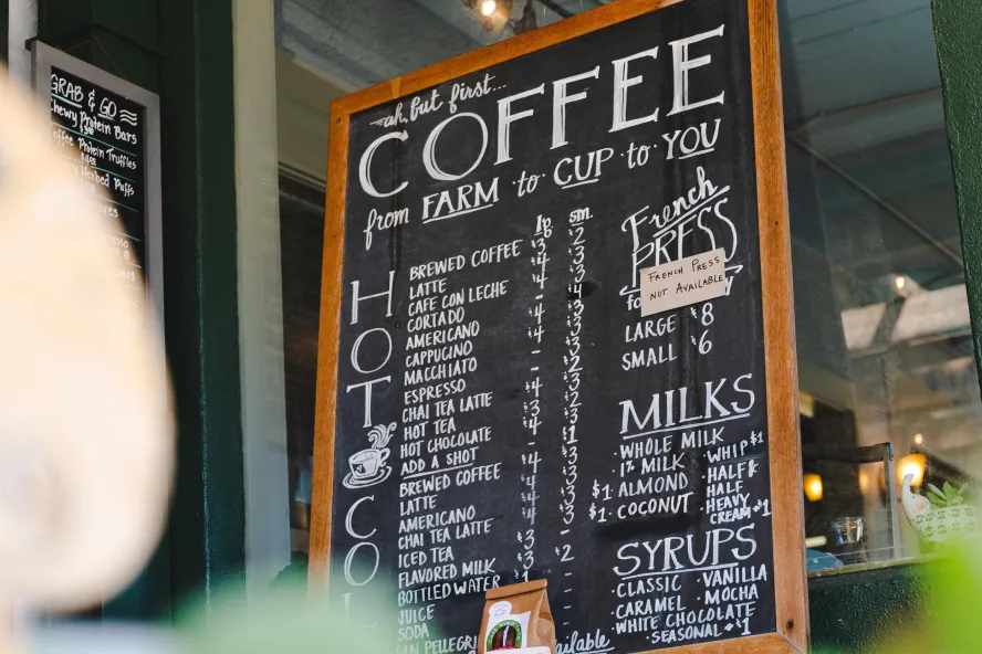 a chalkboard sign with a long list of coffee options at Cafe Vino Tinto