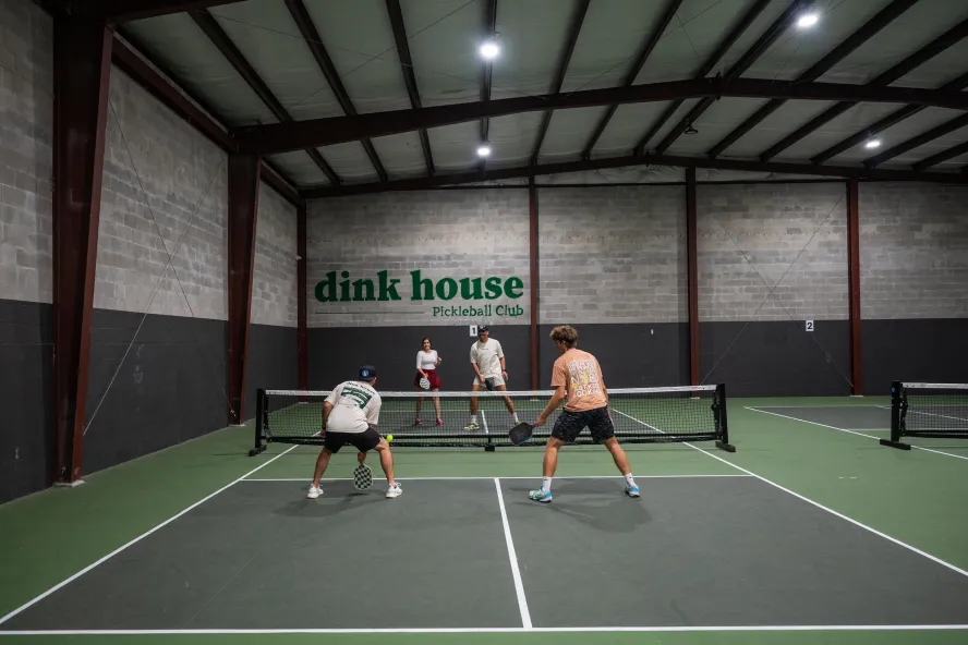 people playing pickleball on an indoor court