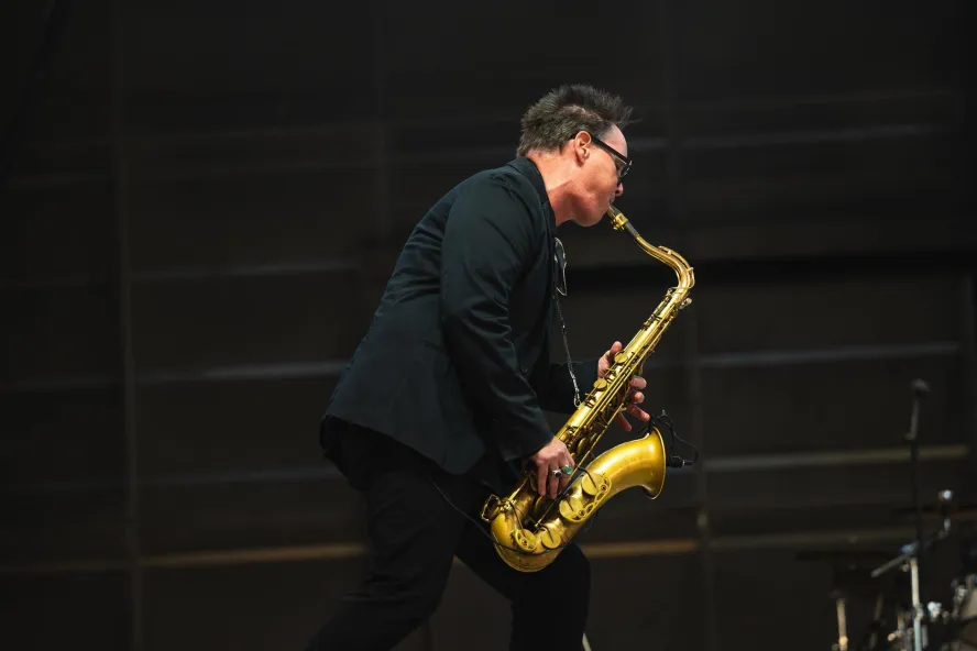 a musician playing a saxophone with feeling
