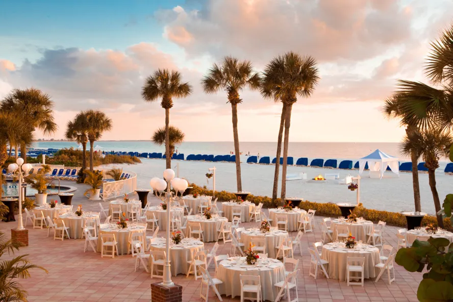 a large patio decorated for a wedding near the beach at TradeWinds Resort