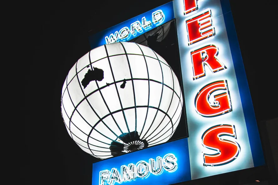 a large lit up globe next to the words World Famous Ferg's