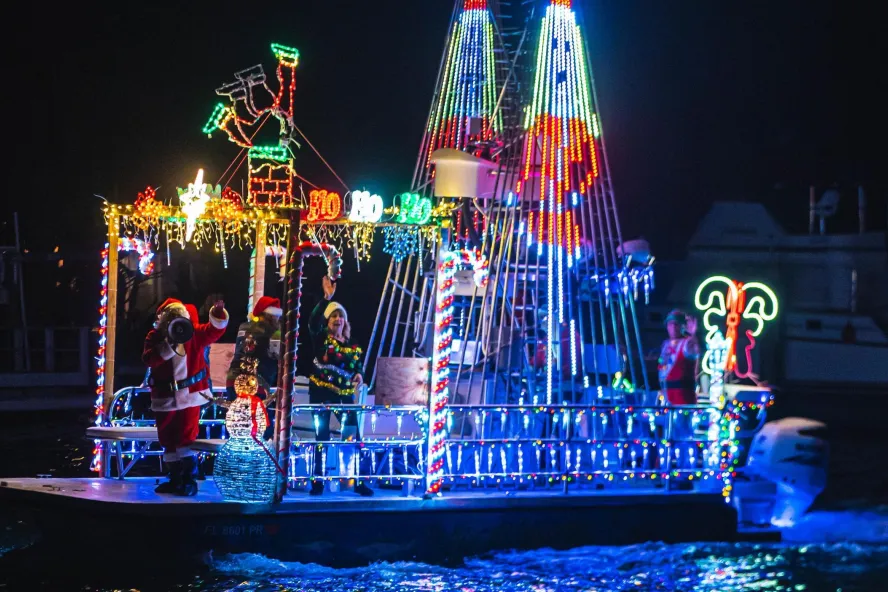 a boat decorated in holiday lights for a boat parade
