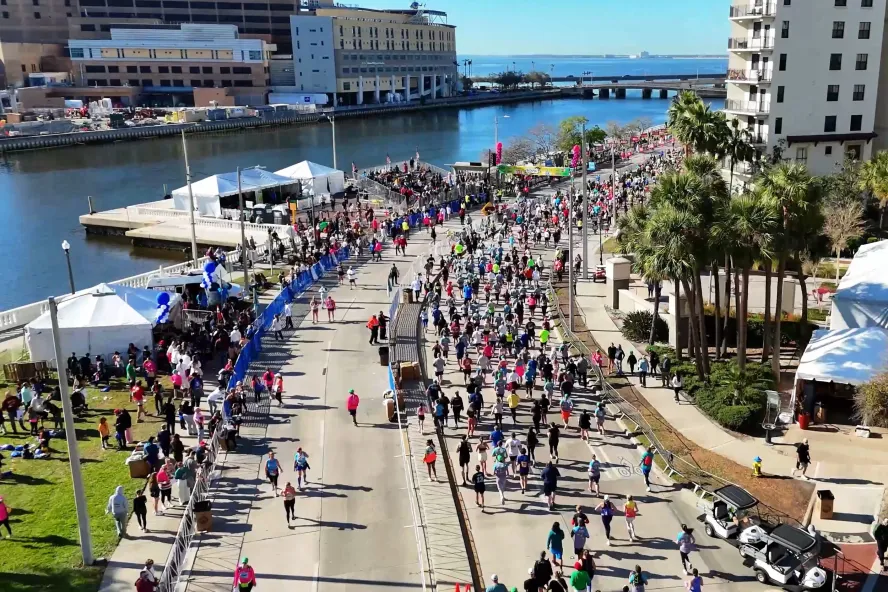 an aerial image of many runners near the Tampa waterfront in the Gasparilla Distance Classic