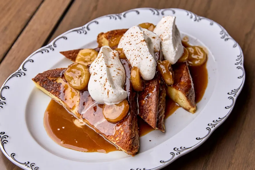 french toast with bananas, buttered rum sauce and whipped cream at Elliott Aster at the Vinoy Hotel