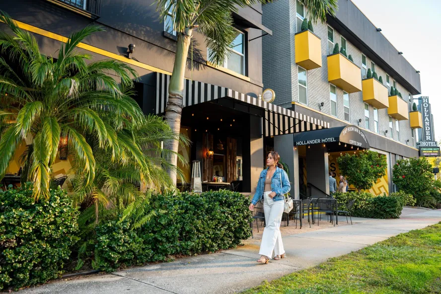Yasmin, a local travel influencer, strolling in front of the Hollander Hotel in St. Petersburg FL