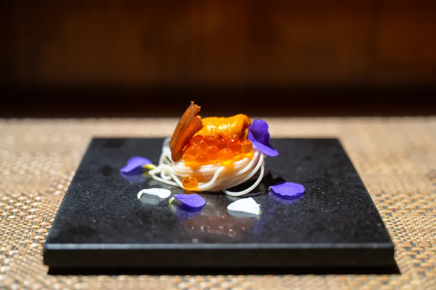 a beautiful plate of sashimi and fish eggs surrounded by flower petals at Sushi Sho Rexley in St. Petersburg FL