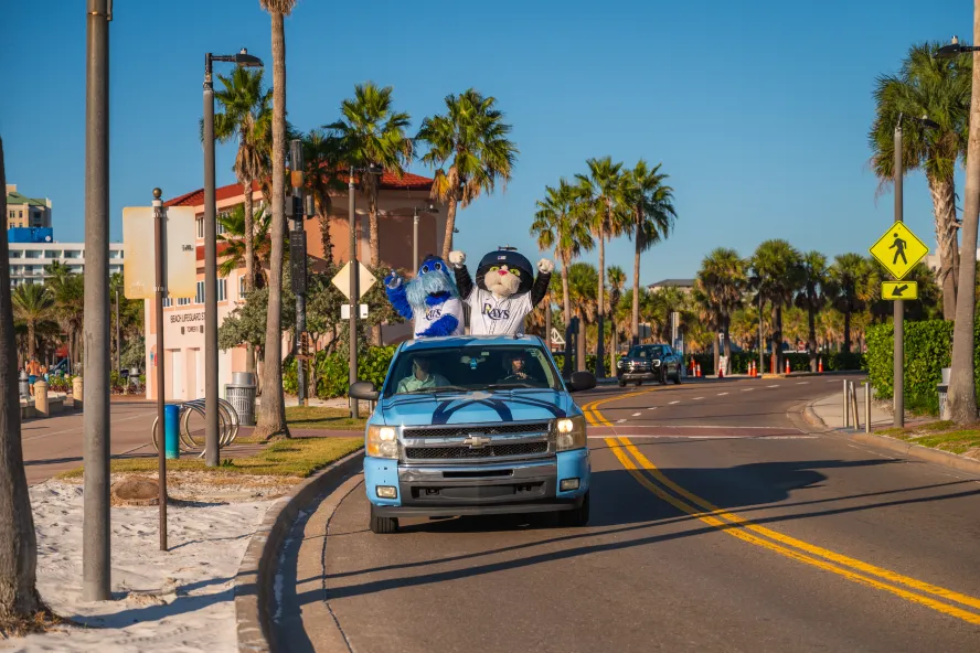 The Rays Mascots riding in a Car