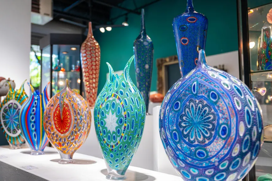 Colorful handblown glass sculptures featuring intricate patterns and vibrant designs at Duncan McClellan Gallery.
