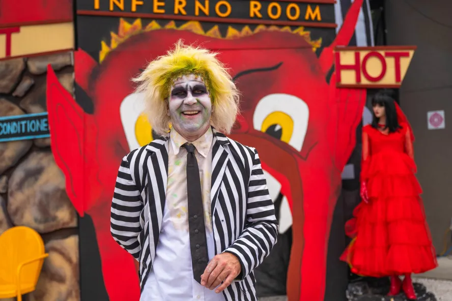 a person in a Beetlejuice costume in front of a display that says Inferno Room at the Halloween on Central event in St. Pete