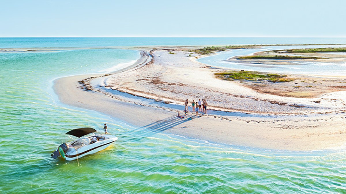 Aerial view of a boat and family in Anclote Key