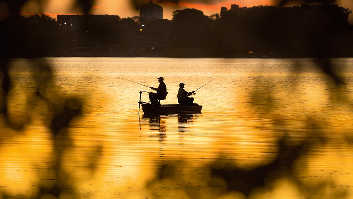 Two men fishing at sunset in Lake Seminole