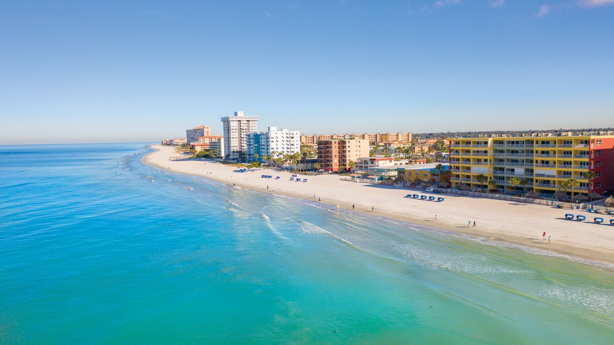 Aerial view of North Redington Beach with calm, blue-green Gulf waters to the west and condos to the east