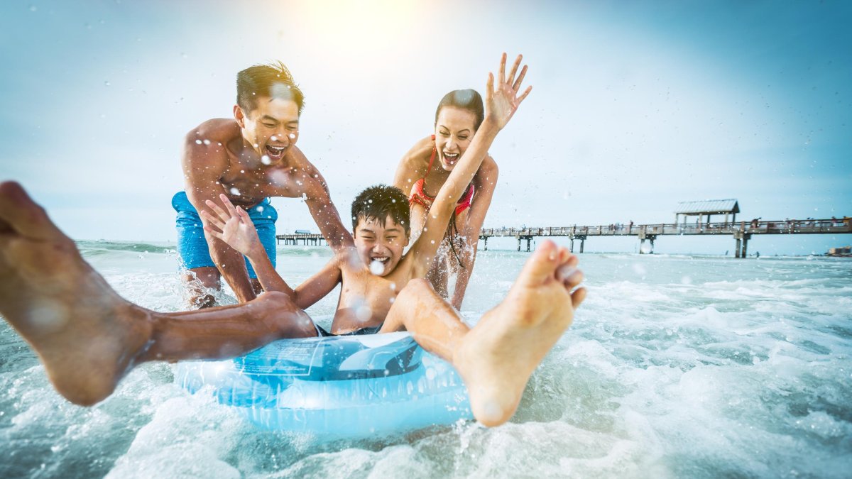 A family plays in the water near Pier 60 in Clearwater Beach, Florida