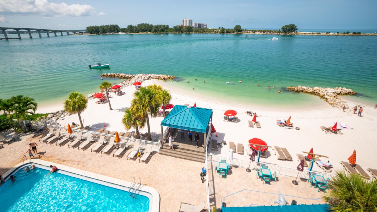 An overview of pool and beachfront of Dolphin Beach Club.
