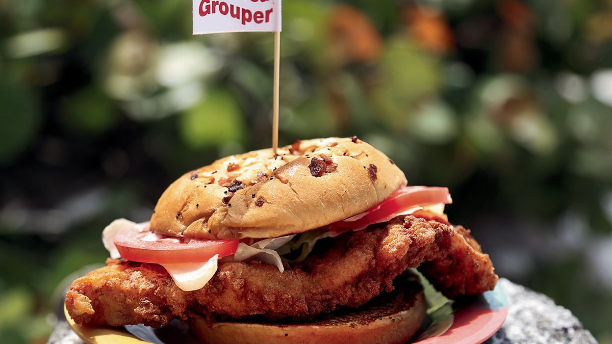 A grouper sandwich with a little flag on top.