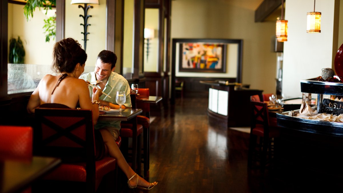 A couple enjoying a meal in an indoor setting of Caretta restaurant.