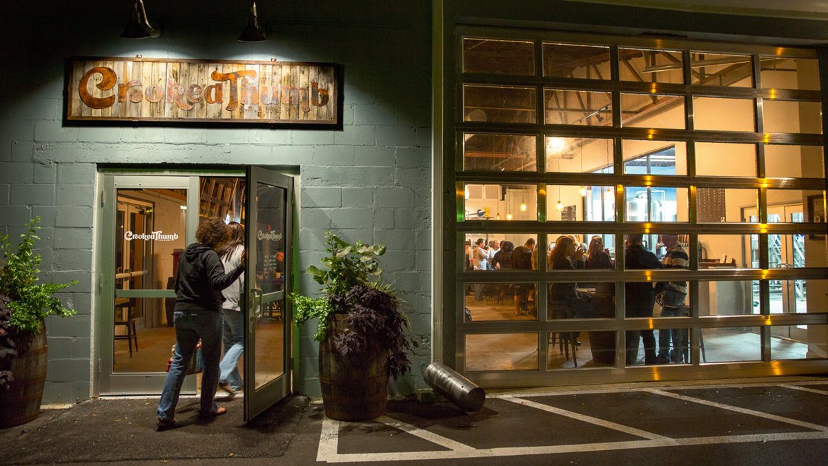 A man entering the Crooked Thumb Brewery in Safety Harbor at night