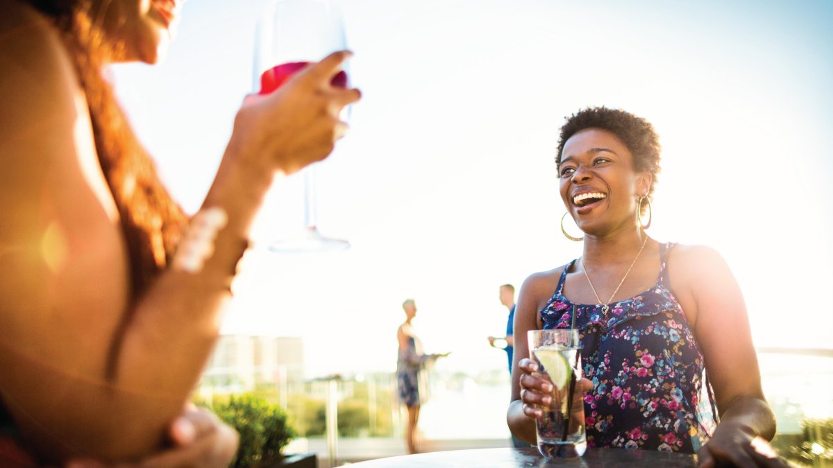 Two African-American ladies enjoying drinks