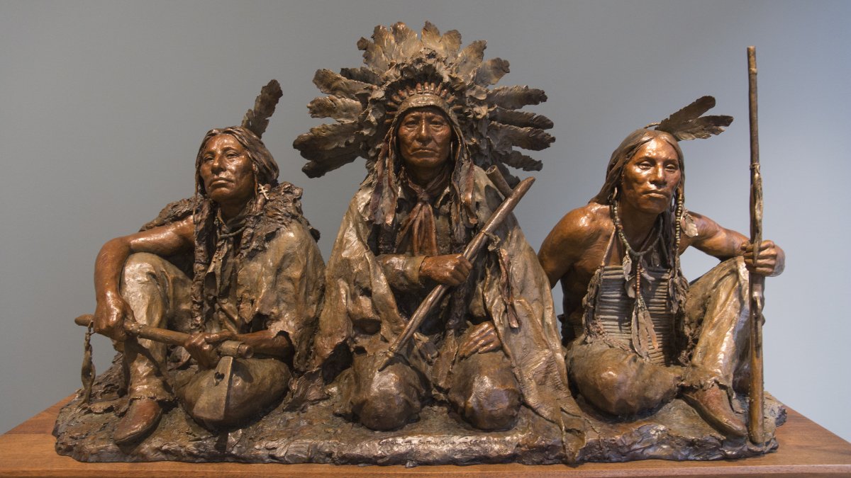 A bronze sculpture of Native American warriors