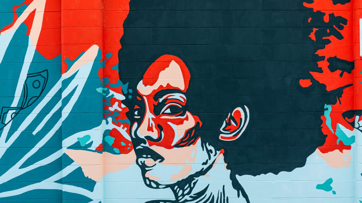 An African-American woman painted in red and blue in a mural in St. Pete