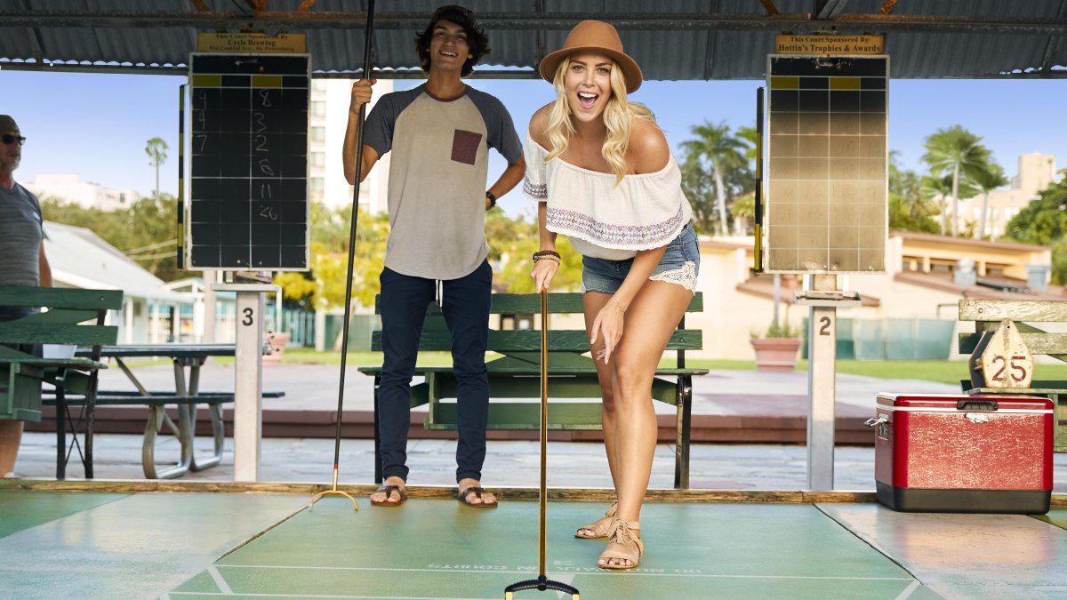 A couple playing shuffleboard.